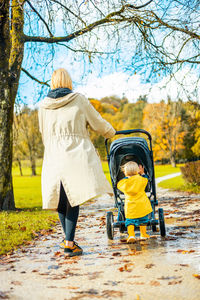 Rear view of woman walking on road