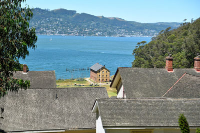 High angle view of sea and mountains against sky