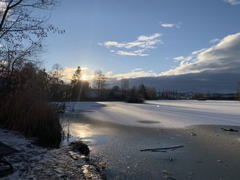 Scenic view of frozen lake against sky during winter