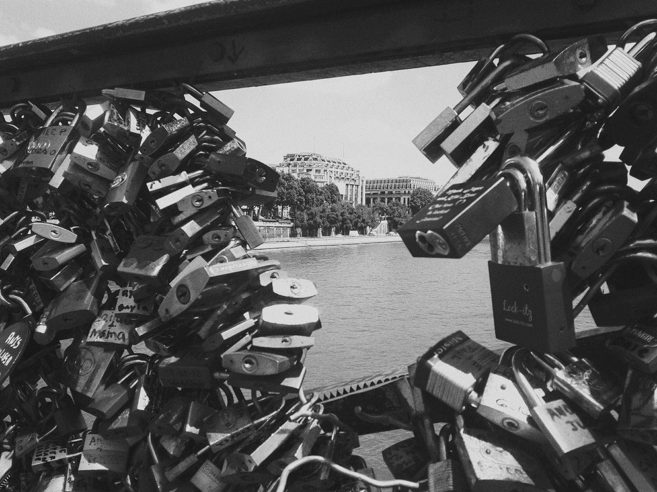 padlock, love lock, lock, railing, river, security, love, metal, safety, bridge - man made structure, water, hanging, protection, hope, day, no people, outdoors, large group of objects, connection, close-up, abundance, transportation, luck, built structure, architecture, clear sky, city, sky