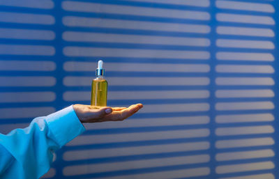 Doctor holds sleep oil to combat melatonin with insomnia, background of night ward with blinds