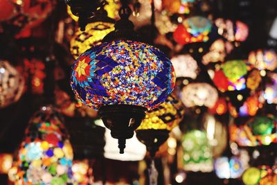 Low angle view of illuminated lanterns hanging at market stall