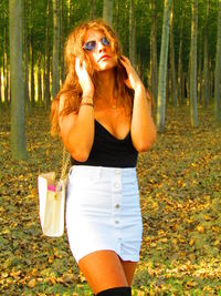 Young woman wearing hat standing on field
