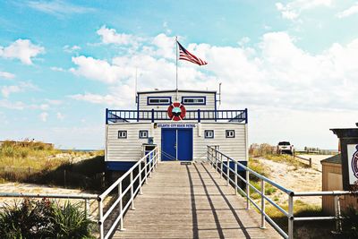 Lifeguard hut on pier against sky