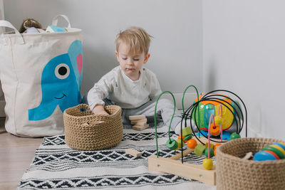 Boy playing with wooden blocks at home