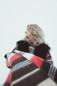 Close up curly haired lady in traditional clothes outdoors portrait picture