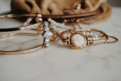 Close-up of jewelry by purse on table