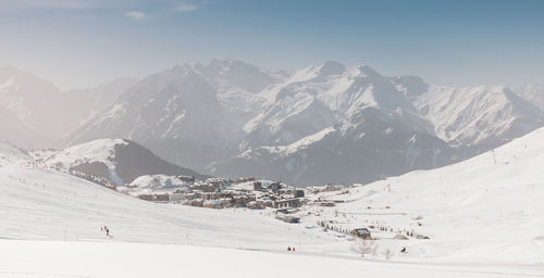 The resort of alpe d'huez in the middle of the snowy mountains in oisans in france