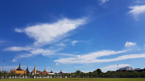 Panoramic view of buildings against blue sky