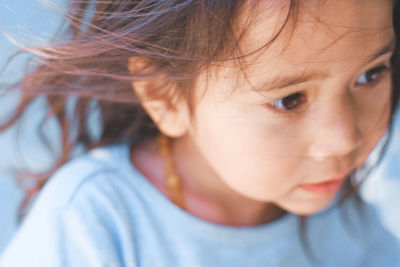 Close-up of cute girl looking away