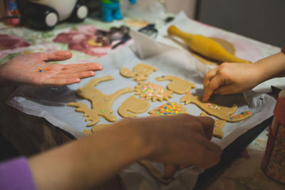 Cropped hands of people preparing cookies at home