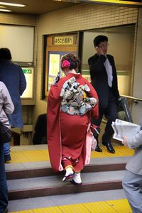 Rear view of woman sitting in train