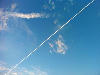 Low angle view of vapor trail in blue sky