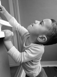 Side view of boy playing at home