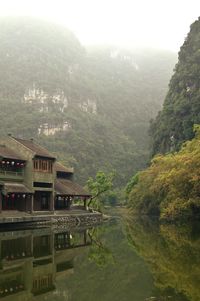 Scenic view of a house in the lake in the fog 