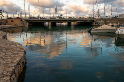 Sailboats moored in harbor