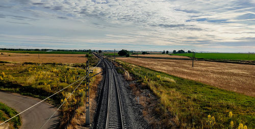 Dirt road passing through agricultural field