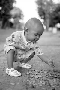 Cute baby girls playing rocks in outdoors
