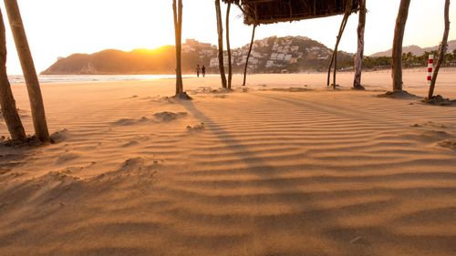 Scenic view of beach against sky during sunset