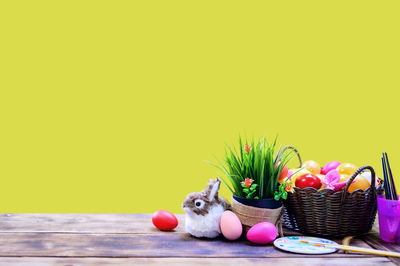 Various flowers in basket on table