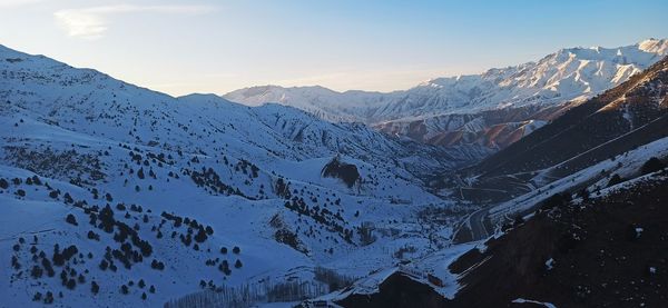 Scenic view of snowcapped mountains against sky