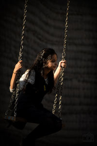 Young woman enjoying on swing