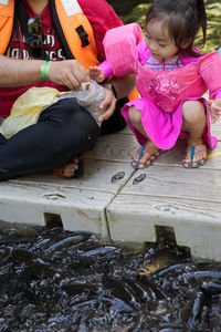 Rear view of women sitting in water