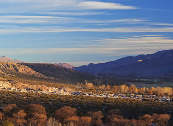 Scenic view of field and mountains against sky