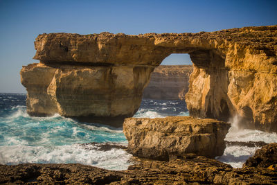 View of rock formations in sea