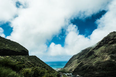 Panoramic view of sea and mountains against sky