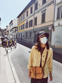 Woman standing on street in city