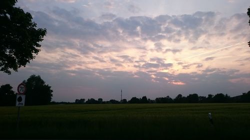 Scenic view of field against sky during sunset