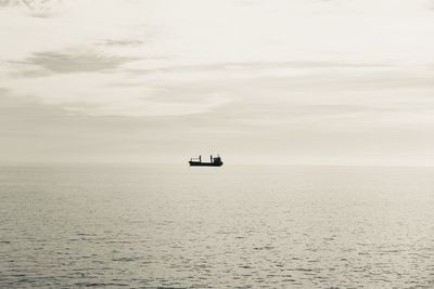 Boat sailing in sea against sky