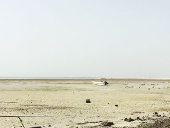 View of calm beach against clear sky