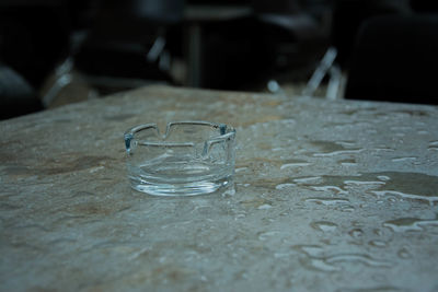 Empty ashtray on wet table