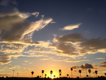 Silhouette people against sky during sunset