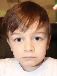 Close-up portrait of cute boy at home