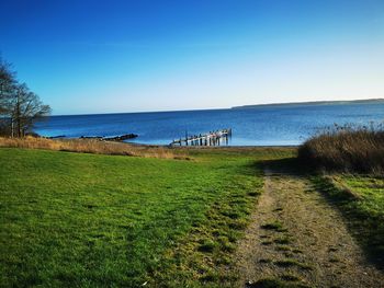 Scenic view of sea against clear blue sky