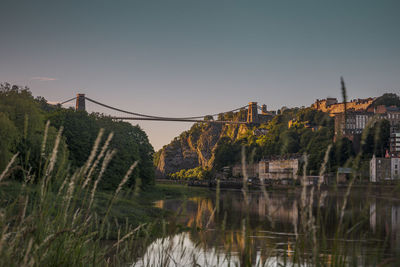 Bridge over lake against clear sky