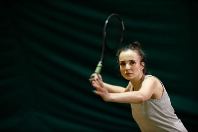 Tennis player playing at court