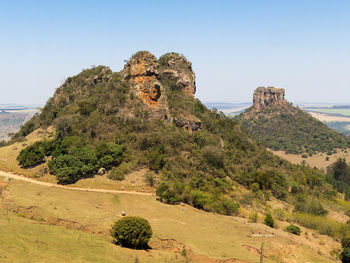 Rock formations on landscape against clear sky