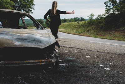 Full length of woman standing on road