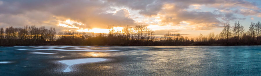 Scenic view of snow covered landscape against sky during sunset