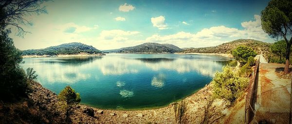 Scenic view of lake and mountains against sky