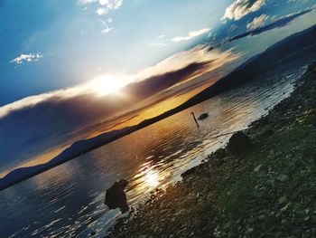 Scenic view of beach against sky during sunset