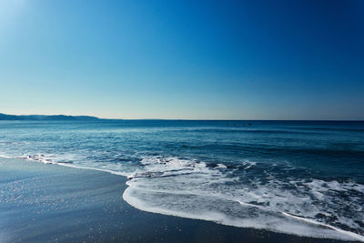 Scenic view of sea against clear blue sky