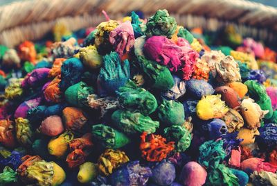 Multi colored dyed dried flowers in container for sale at market