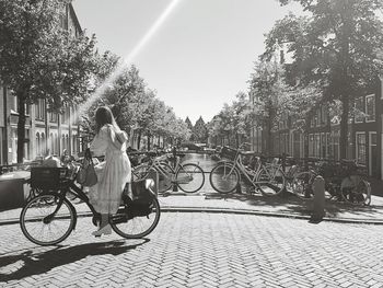 Man riding bicycle on street in city