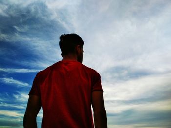 Low angle view of man standing against sky