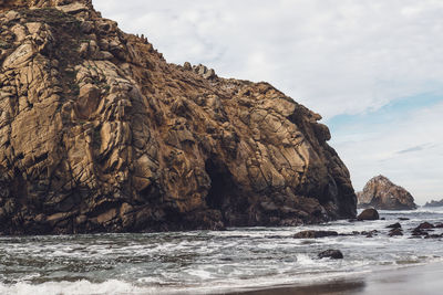 Scenic view of rock formation and sea against sky